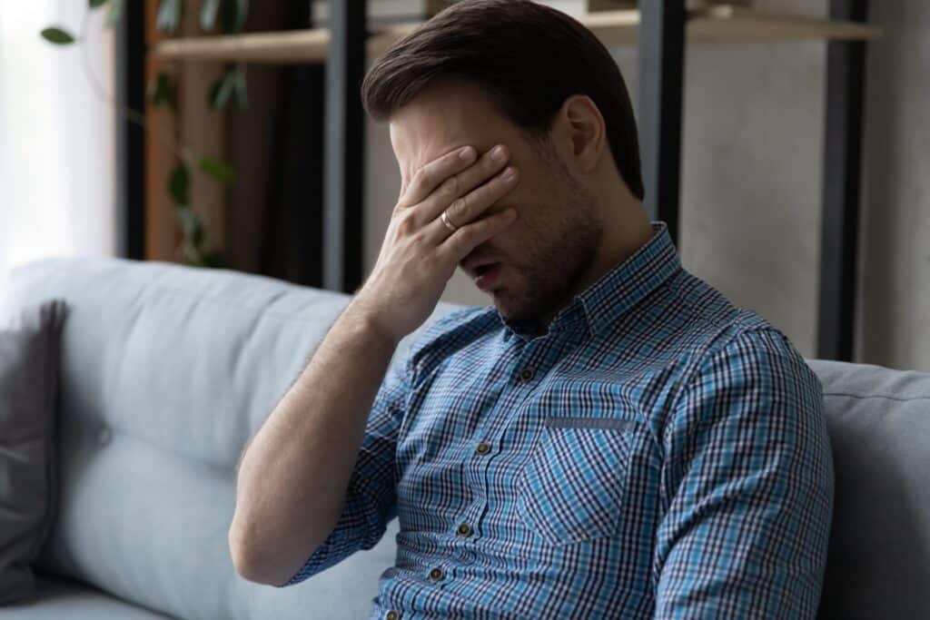 Man feeling exhausted after a night of snoring in New York, NY