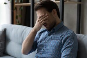 Man feeling exhausted after a night of snoring in New York, NY
