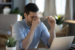 Man feeling sleepy at work due to sleep apnea in New York, NY