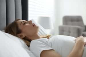 Woman with sleep apnea snoring in New York