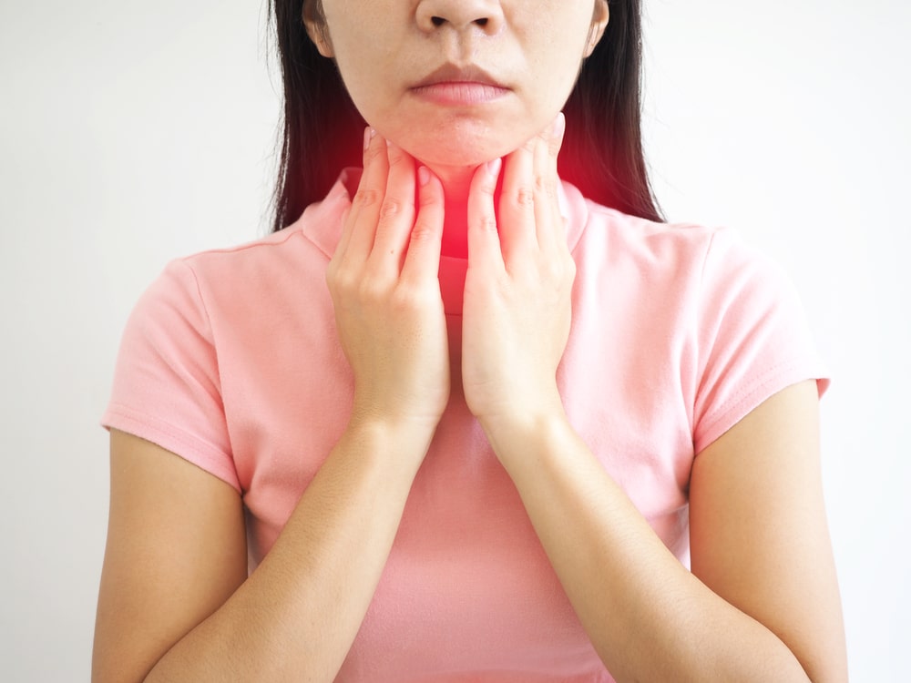 Woman experiencing pain from Tonsillitis in NYC